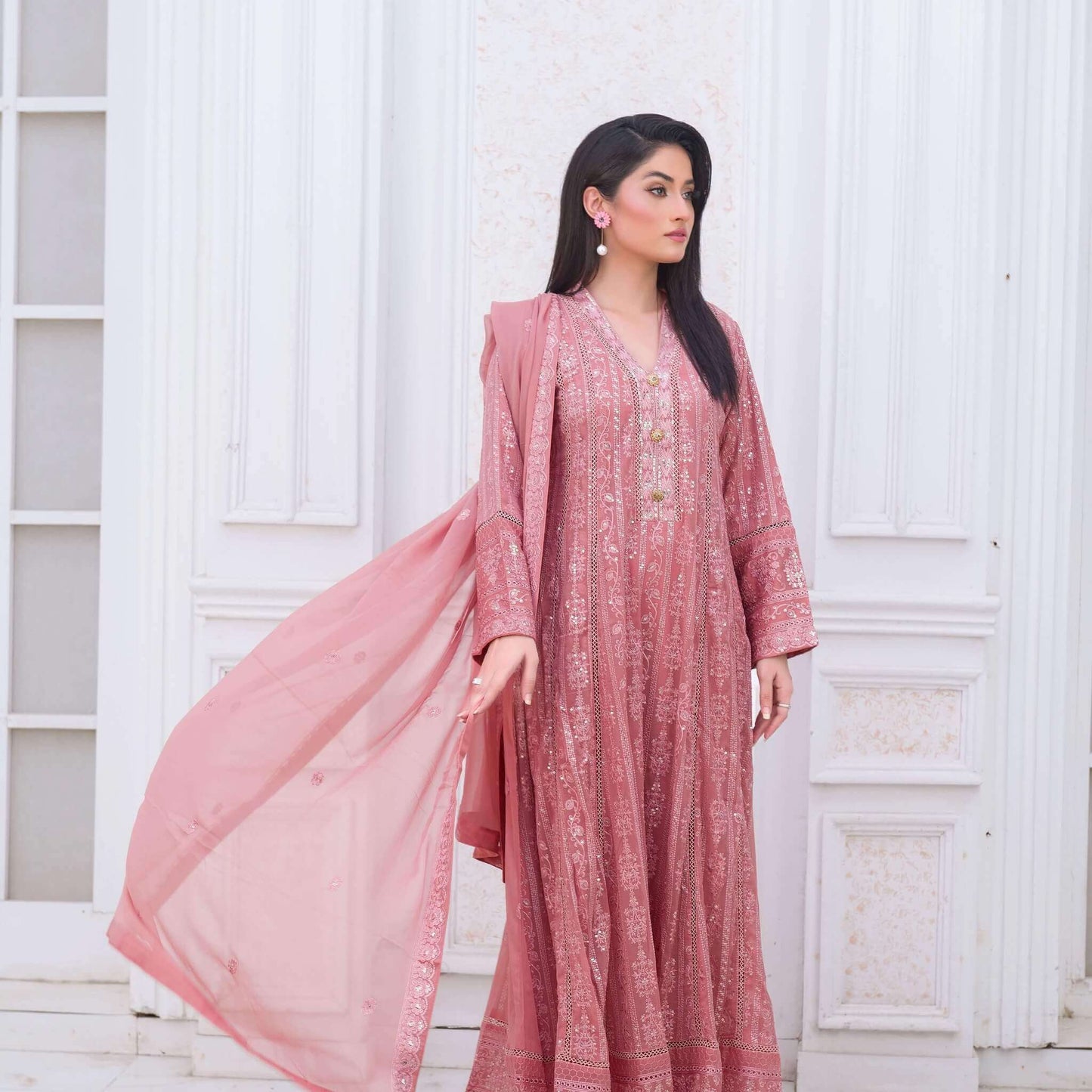 Woman wearing a pink traditional outfit with a white background complete pics