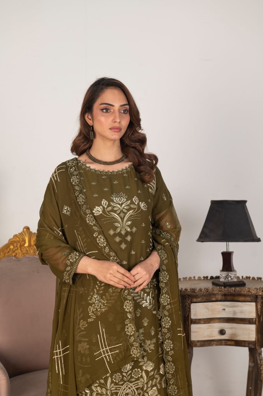Woman wearing a green embroidered traditional outfit