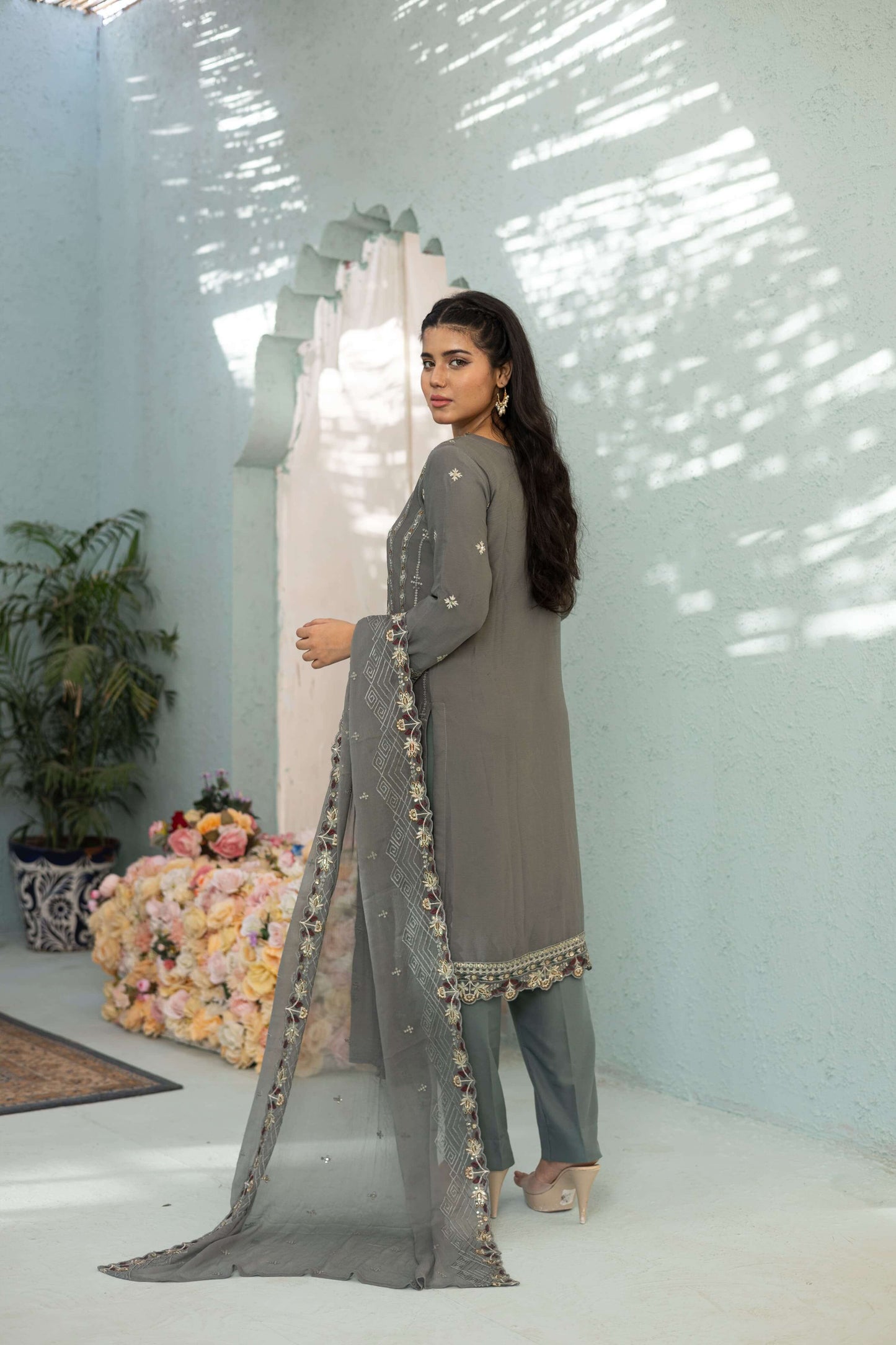 Woman in a gray embroidered chiffon shalwar kameez back picture