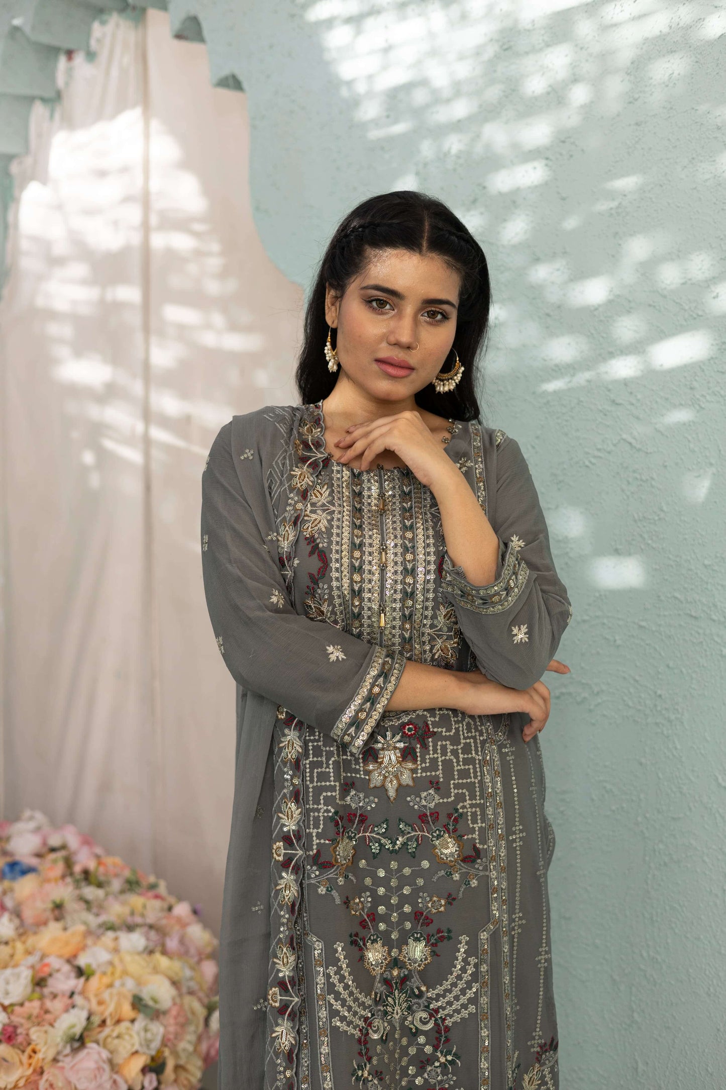 Woman in a gray embroidered chiffon shalwar kameez close up picture