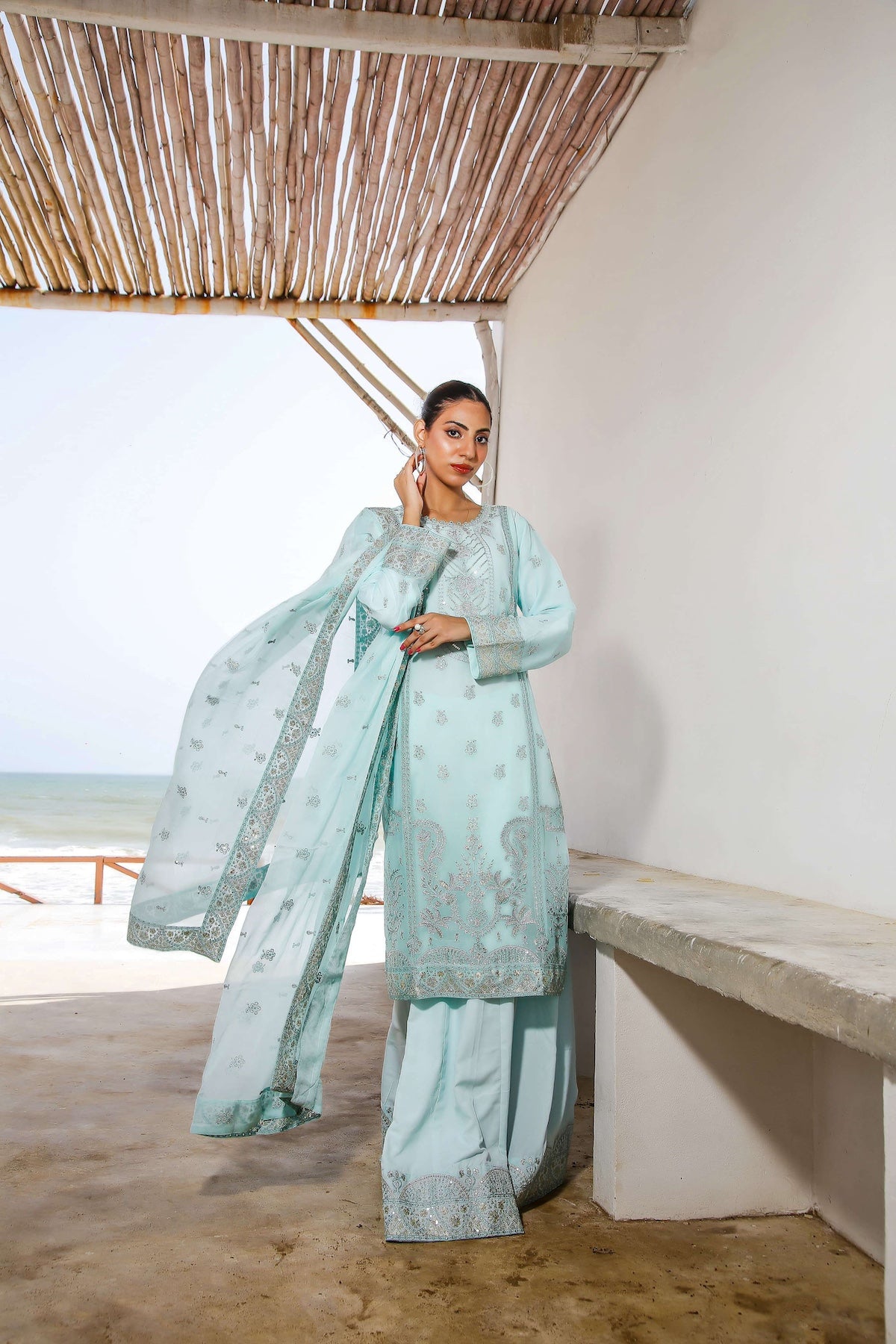 Model in light blue lehnga set with dupatta draped
