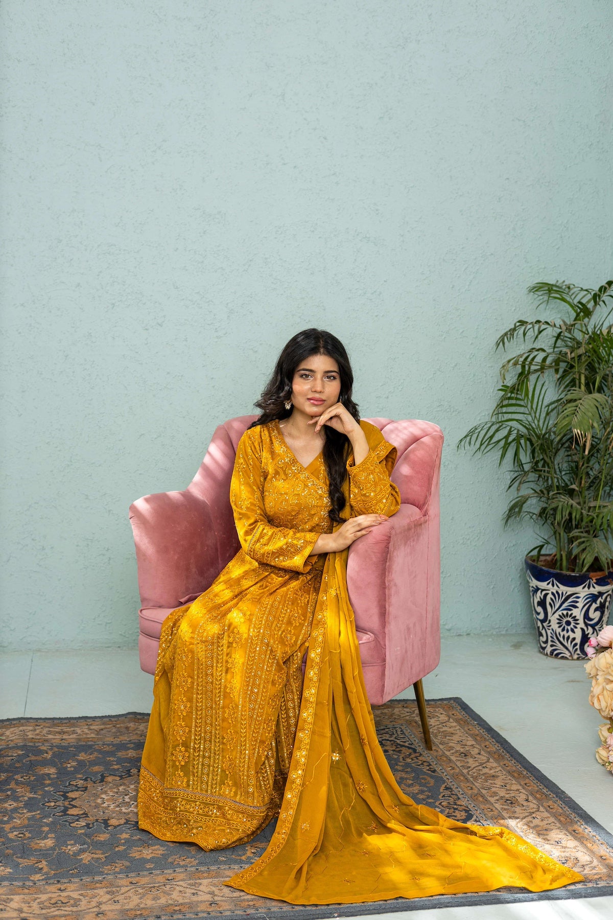 Model posing in mustard long frock