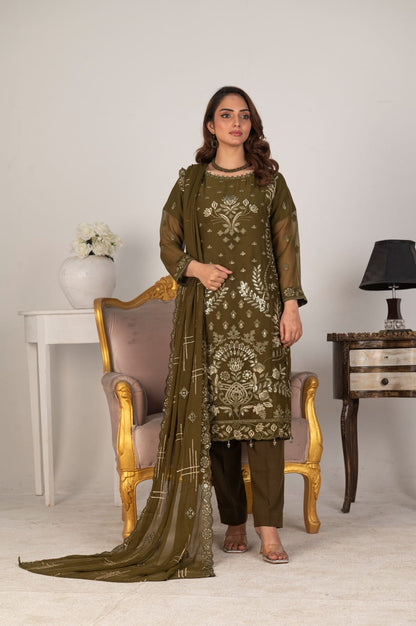 Woman in a green embroidered outfit with a matching dupatta