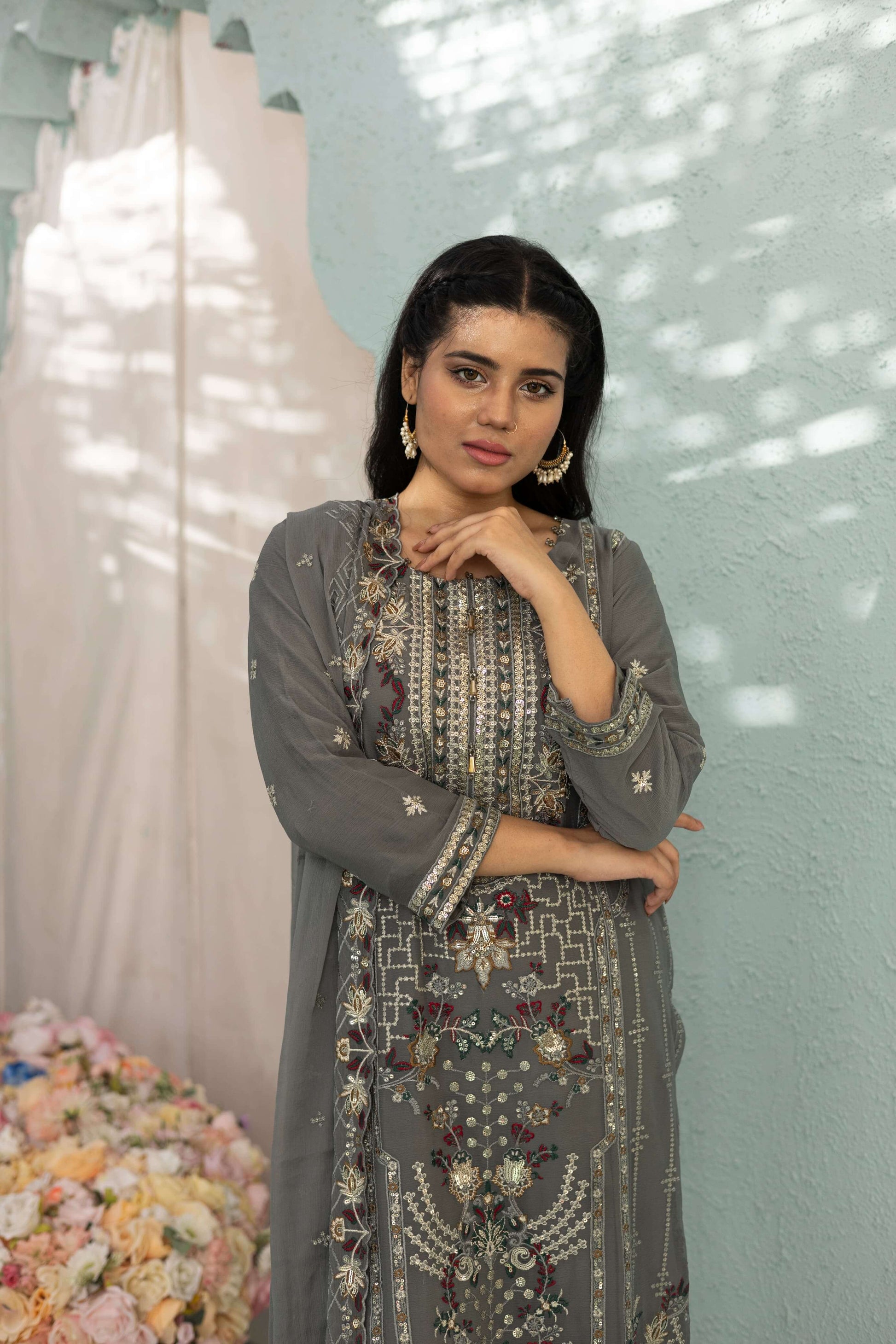 Woman in a gray embroidered chiffon shalwar kameez close up picture