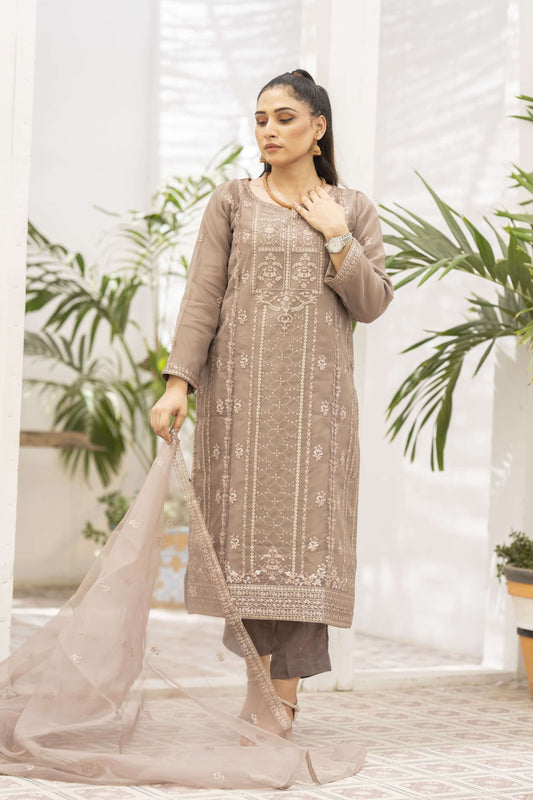 Woman wearing a light brown embroidered kurta with a dupatta