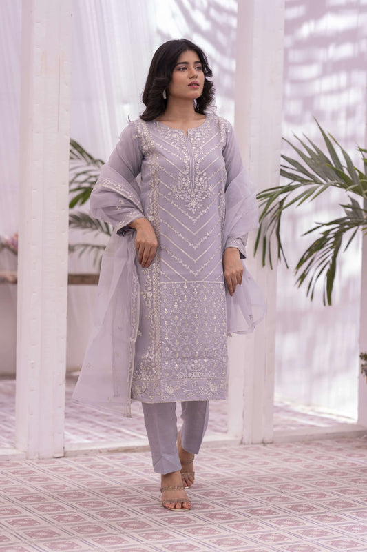 Woman in a lilac embroidered outfit