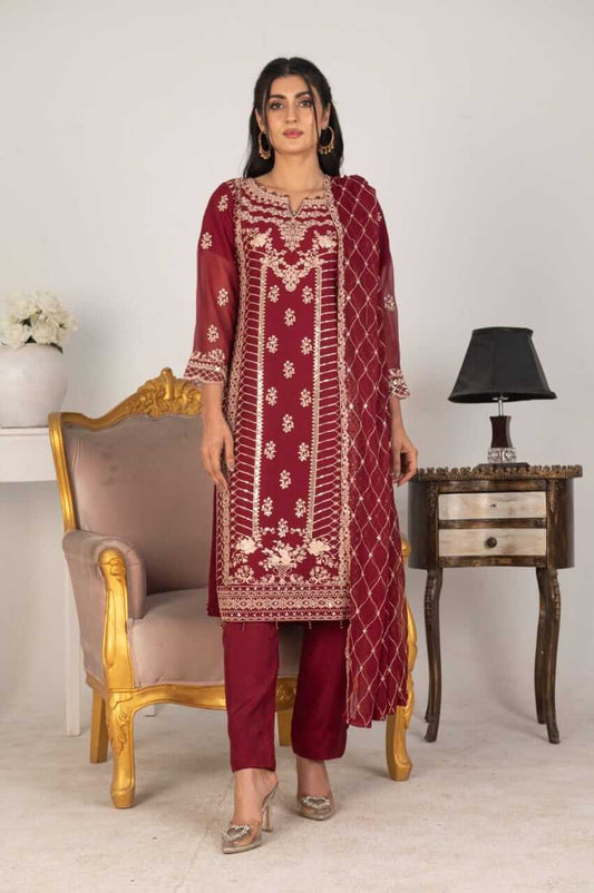 Woman wearing a magenta embroidered chiffon salwar kameez