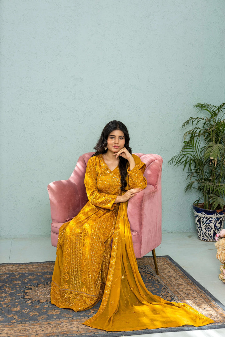 Model posing in mustard long frock