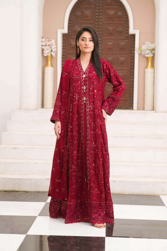 Woman wearing a red maxi traditional outfit standing on a staircase.