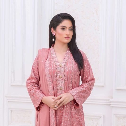 Woman wearing a pink traditional maxi outfit with a white background close up picture
