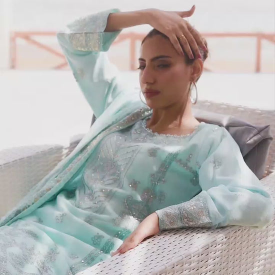 Model wearing light blue embroidered lehnga 3-piece suit, showcasing skirt movement, embroidery details, and full look transitions.