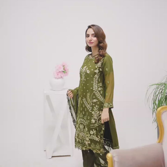 Models walking in green shalwar kameez suit.