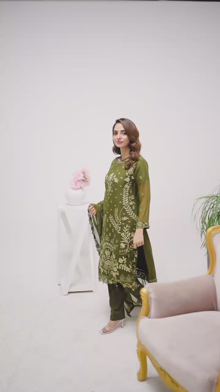 Models walking in green shalwar kameez suit.