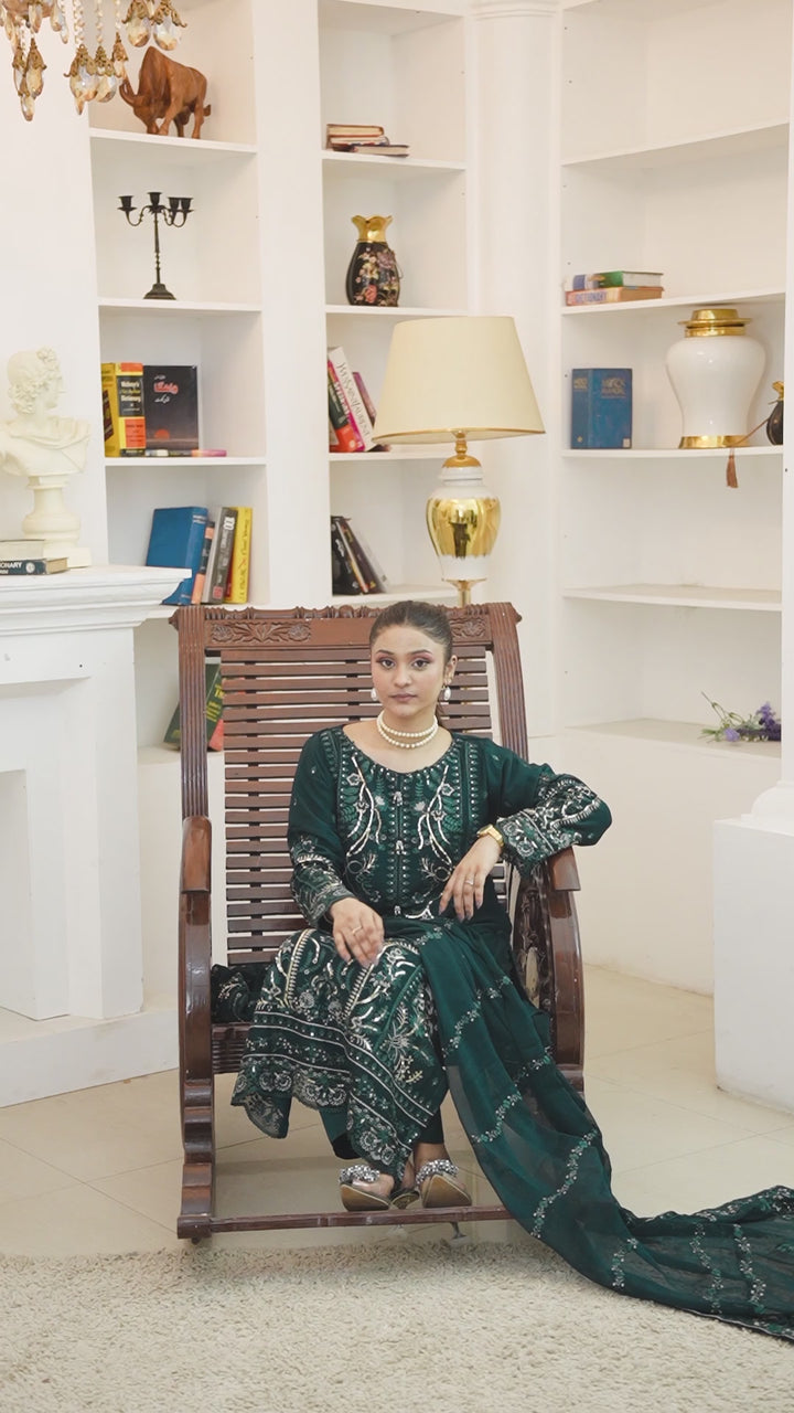 Video of model showcasing bottle green chiffon shalwar kameez with heavy embroidery and dupatta