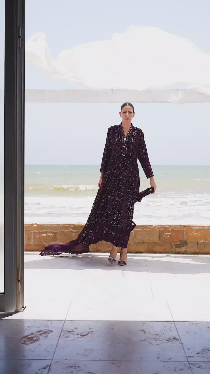 Model showcasing dark purple embroidered maxi dress with graceful twirls and close-up details of hand embroidery.